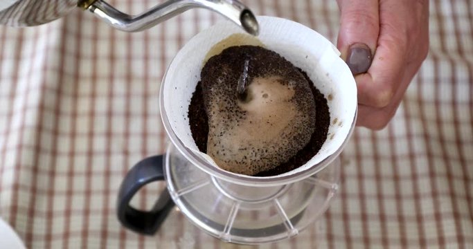 Barista pouring water on ground coffee in kono dripper : Hand Drip Coffee, Kono drip