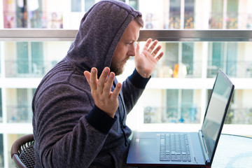 Cybercrime, hacking and technology concept - male hacker writing code or using computer virus...