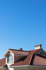 Obraz premium Tiled Metal Roof Or Composite Covering On House