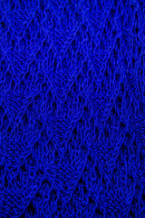 Top view of bright blue electric handmade knitted pattern background