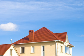 Fototapeta na wymiar Tiled Metal Roof Or Composite Covering On House