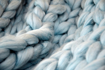 merino wool balls, lying on wooden table, blue thread