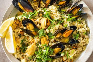 Lemon rice with mussels, midopilafo in a plate, closeup - a Greek dish