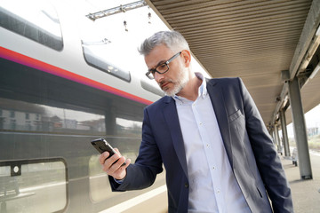 Businessman hurrying in train station to get on train
