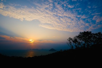 Beautiful sunrise image with colorful blue purple orange sky and white cloud with seascape landscape background