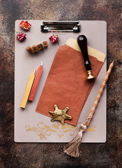 clipboard with inscription love, wax seal and blank envelopes on a dark background, flat lay. Written retro accessories