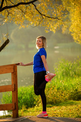 Image of young girl stretching in summer park