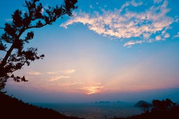 Naklejka na ściany i meble Beautiful sunrise image with colorful blue purple orange sky and white cloud with seascape landscape background