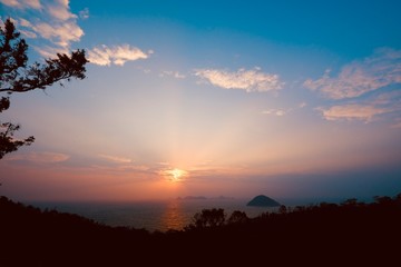 Beautiful sunrise image with colorful blue purple orange sky and white cloud with seascape landscape background