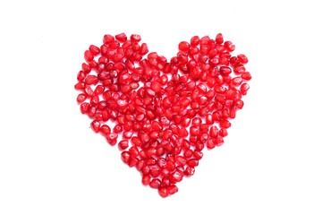 Plakat pomegranate seeds in heart shapeon white background