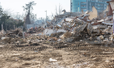 Remains of hurricane or earthquake aftermath disaster damage on ruined old houses with collapsed roof and wall 