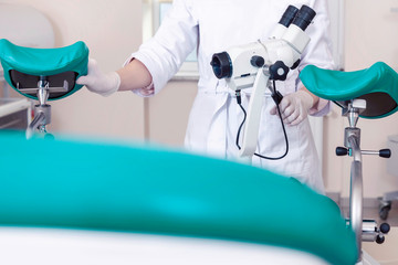 Gynecological room gynecologist chair equipment doctor female hands lens microscope optics
