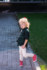 Fototapeta premium girl teen walk on grass with red sneaker