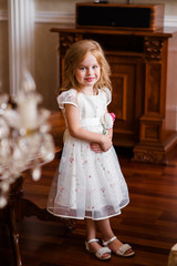 A little girl in a white dress