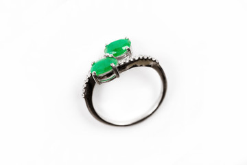 Luxury ring with green gem isolated on white background