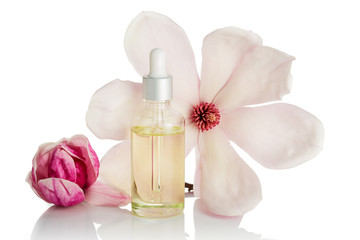 Fototapeta na wymiar Magnolia flower oil isolated on white background. Skin care, spa, wellness, massage, aromatherapy and natural medicine