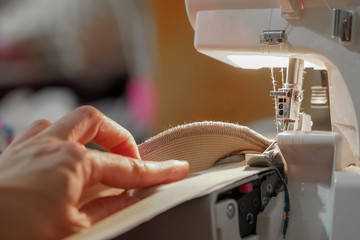 A woman performs work on the overlock