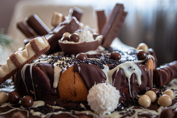 Beautiful homemade cake with chocolate, chocolate cookies and candies