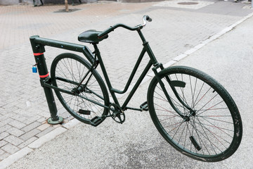 Fototapeta na wymiar Old bicycle as a barrier on the boulevard
