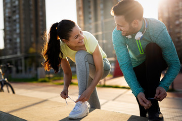 Runners tying running shoes and getting ready to run