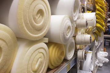 Rolls white and yellow foam rubber building material texture. Polystyrene sealing foam surface...