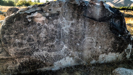 Rock painting aka petroglypgs at the field in Cholpon-Ata, Issyk-kul, Kyrgyzstan