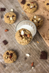 Homemade Oatmeal cookies with a glass of milk, photography in a rustic style, village and countryside wooden theme