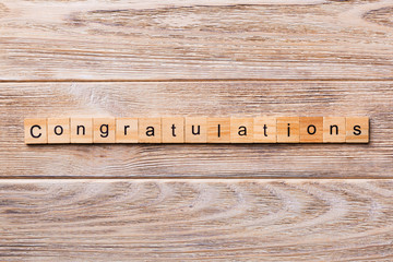 congratulations word written on wood block. congratulations text on wooden table for your desing,...