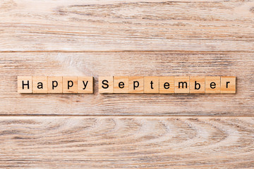 Happy september word written on wood block. Happy september text on table, concept