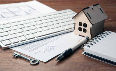 home purchase contract, miniature house, door key, keyboard