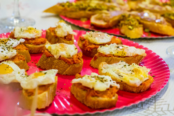 Typical spanish tapas, sobrasada sausage and fried quail eggs over a slice of bread
