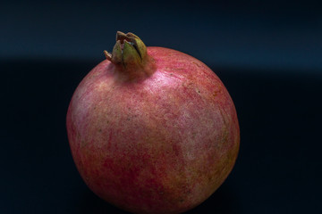 Fototapeta na wymiar Pomegranate fruit on black background