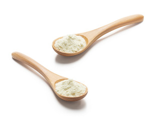Wooden spoon filled with milk powder