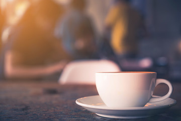 Cup of Latte on the table in coffee shop background