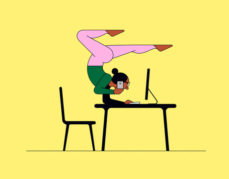 Woman doing yoga handstand while working on computer