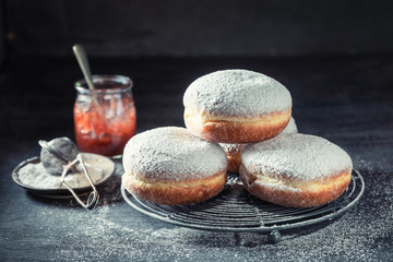 Sweet and brown donuts with red jam