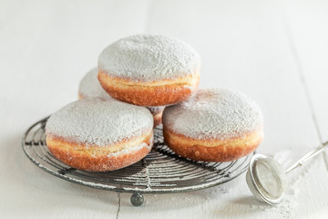 Sweet and brown donuts with powdered sugar