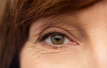 beauty, vision and old people concept - eye of senior woman