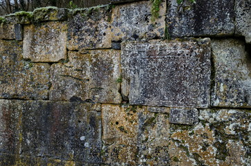 Part of the stone fence with ancient ritual stones and frescoes in Demir Baba Teke, cult monument honored by both Christians and Muslims in winter near Sveshtari village, Isperih, Razgrad