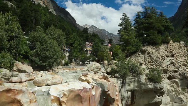 Surya Kund waterfall at Gangotri near Gangotri Temple, Himalayan Range Uttarakhand India.Pay obeisance to Sun God Waterfall Surya Kund on holy river Ganges on background mountain town Gangotri deodar.