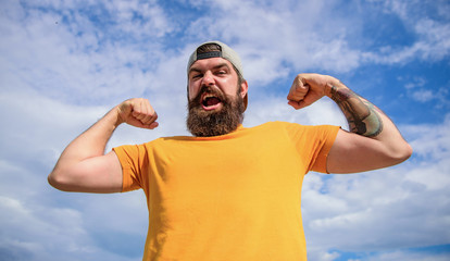 Powerful and free. Man bearded muscular brutal hipster outdoors sky background. Masculinity and...