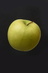 apple isolated on a black background.