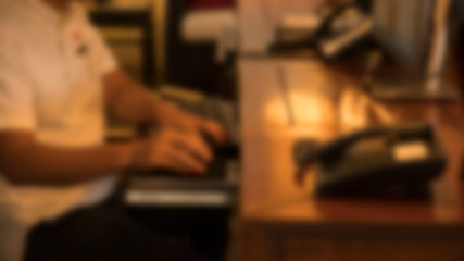 The work flap on the front of the computer is blurred.