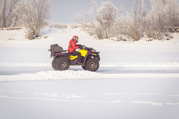 man driving a quad bike in the winter field © diy13