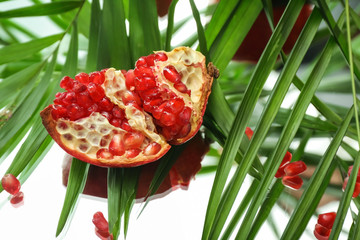 Piece of ripe pomegranate on table