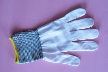 white work gloves on pink background. overalls and uniforms. hand protection
