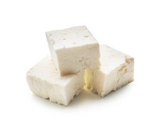 Fototapeta na wymiar Pieces of tasty feta cheese on white background