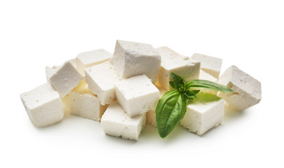Pieces of tasty feta cheese on white background