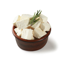 Bowl with tasty feta cheese on white background
