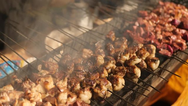 Skewers with meat on barbecue, closeup. Local market in Morocco, Africa.